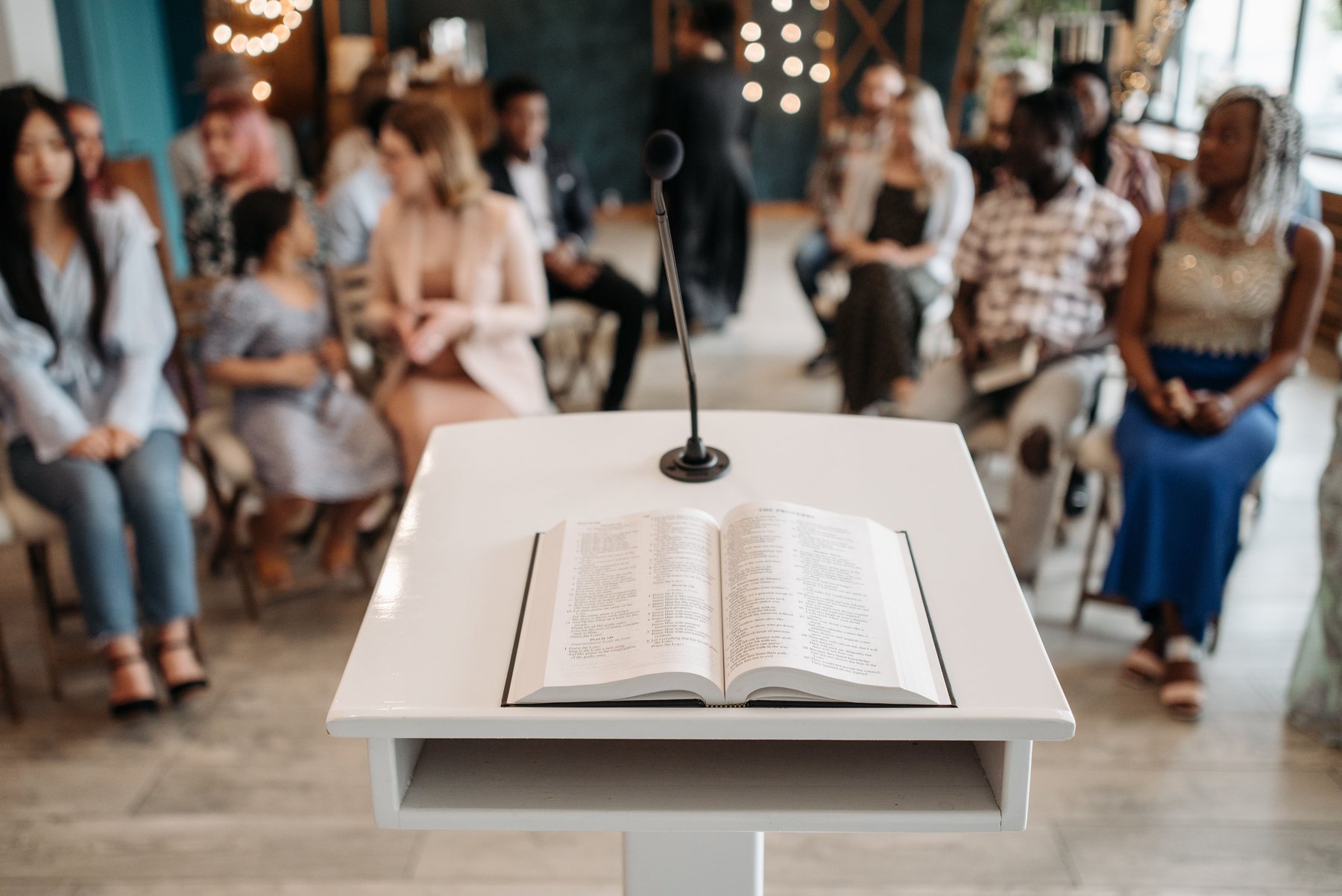 Open Bible on a podium before a congregation