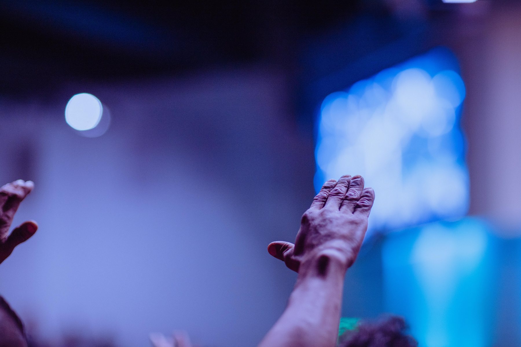 Raised hands during a worship gathering